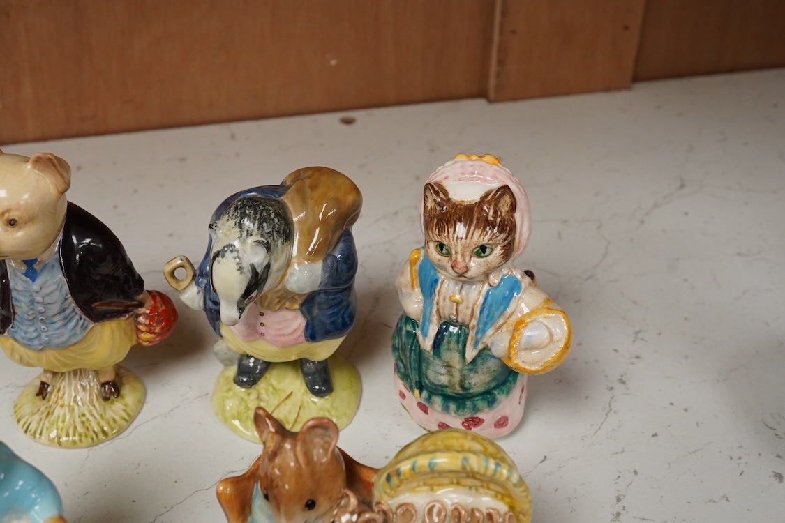 A collection of thirteen Beatrix Potter character figures, stamped with a gold stamp F Warn and Co Ltd, Beswick England, largest 12cm high